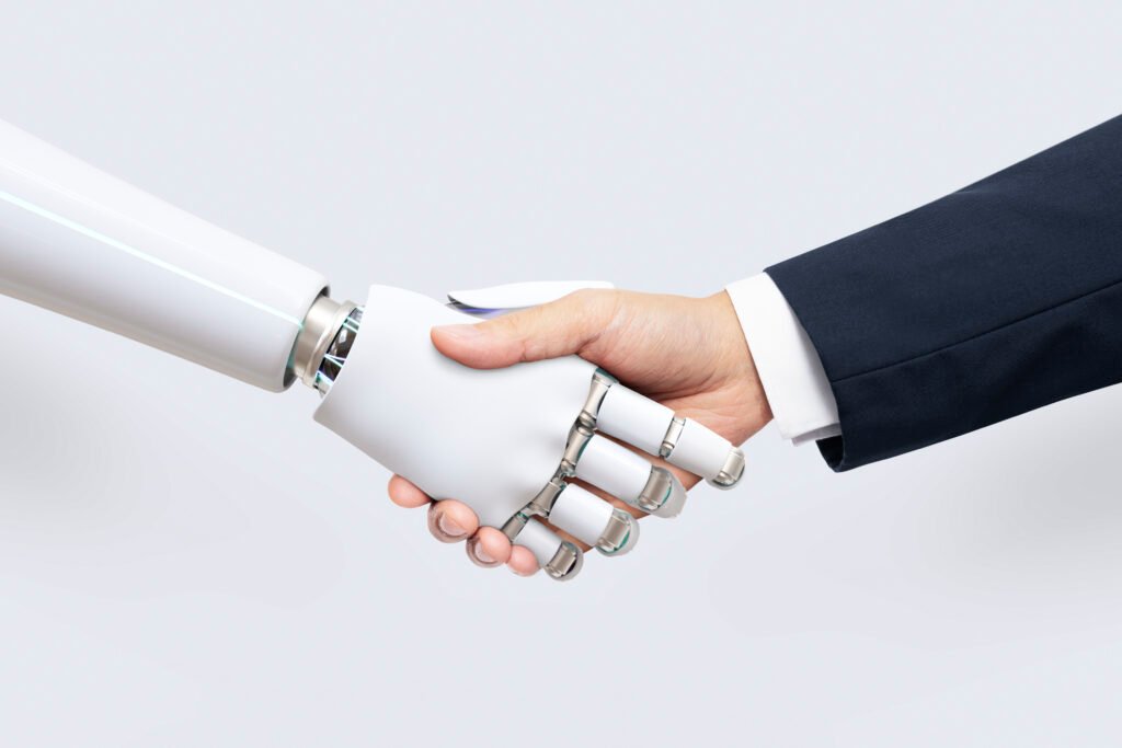 AI Marketing : Comment faire de l'argent avec ? 2 Une homme sert la main à un robot - Comment faire de l'argent avec le AI Marketing ?